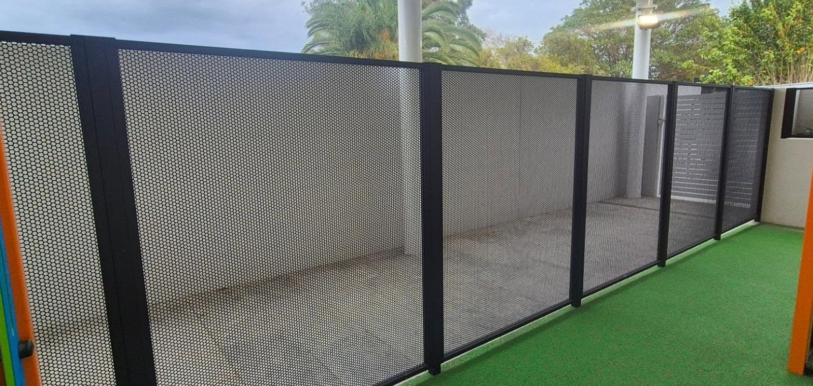 Pure Perf signature perforated child-safety fencing around a childcare play area