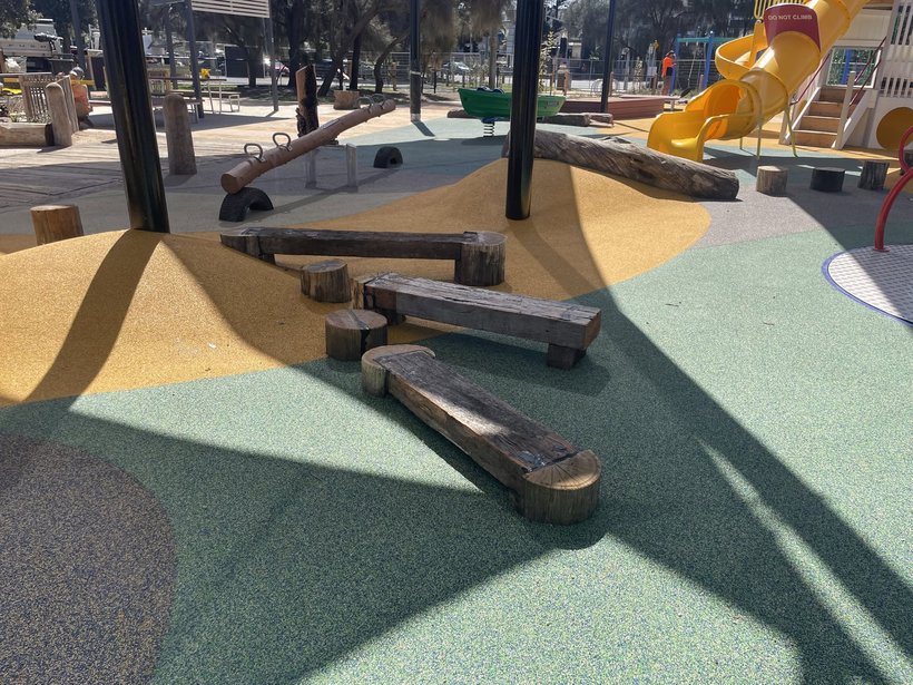 Nature playground with timber play equipment behind Perf Safe fencing