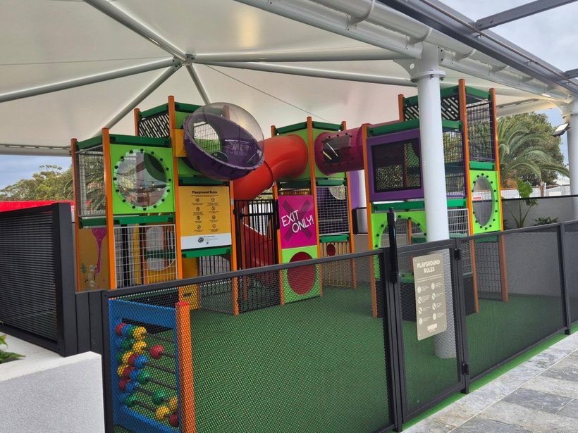 Indoor play centre enclosed by black perforated Perf Safe fencing