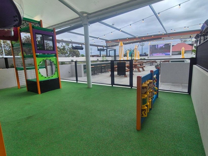 Play-centre soft-play equipment enclosed with perforated safety fencing